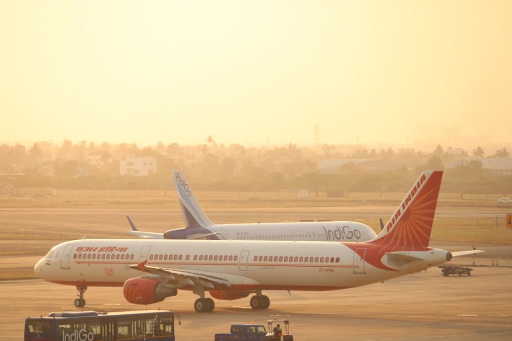 black-bus-beside-white-and-red-plane-lqvqaxvztlu